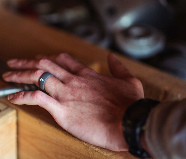 mans hand featuring groove life ring with lineman logo